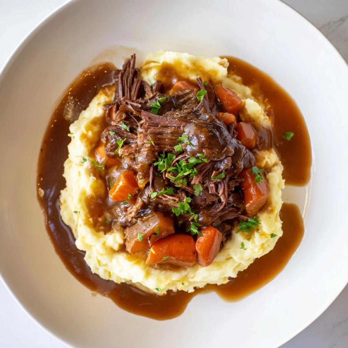 Tender Slow Cooker Pot Roast with vegetables and a generous serving of creamy mashed potatoes.
