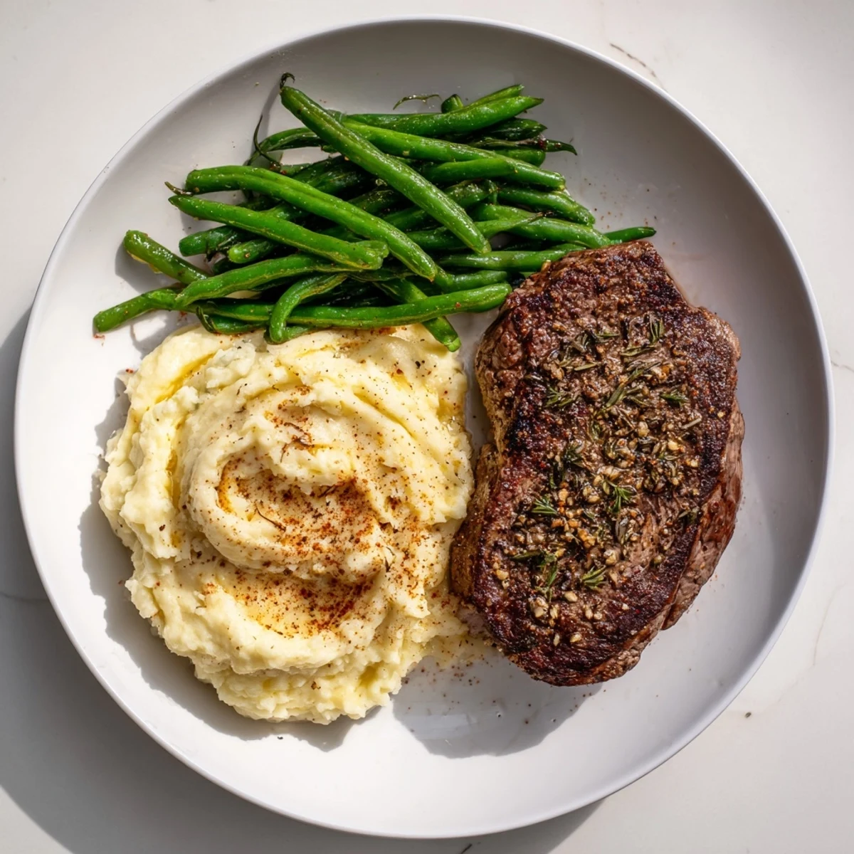 Juicy steak and creamy garlic mashed potatoes, roasted together in a single sheet pan meal.