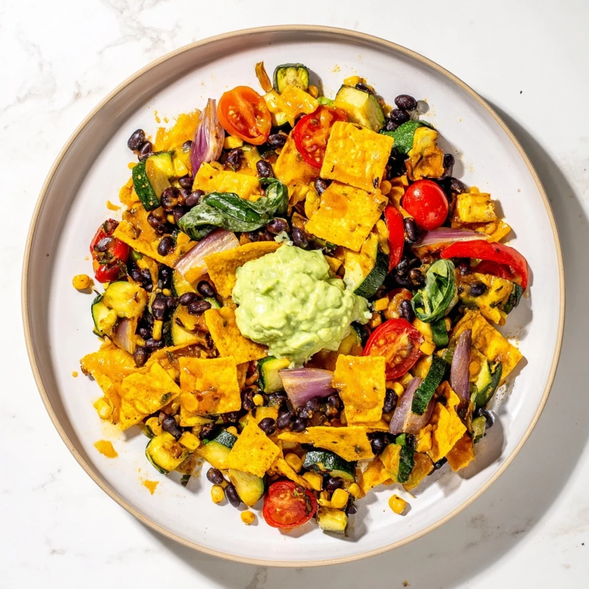 Vibrant Veggie-Packed Taco Skillet with Avocado Yogurt topped with creamy avocado sauce, ready to eat.
