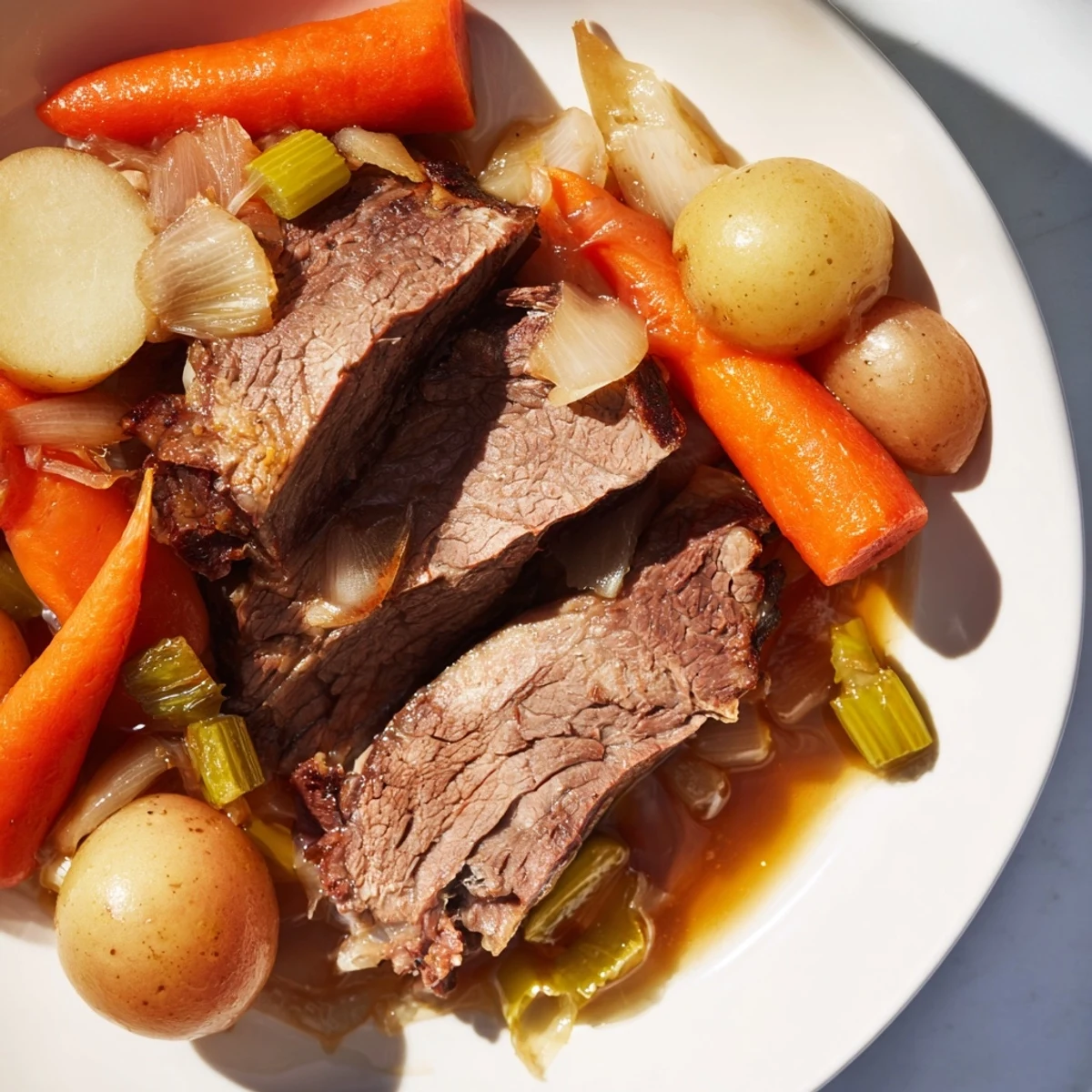 Fork-tender Pickle Brine Pot Roast, slow-cooked with savory vegetables, in rich, flavorful juices.