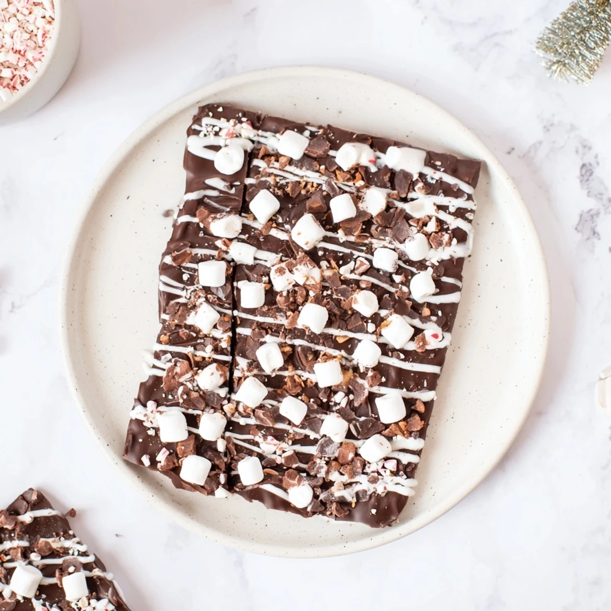 White chocolate drizzled over the festive Hot Chocolate Bomb Bark, ready for sharing and enjoyment.