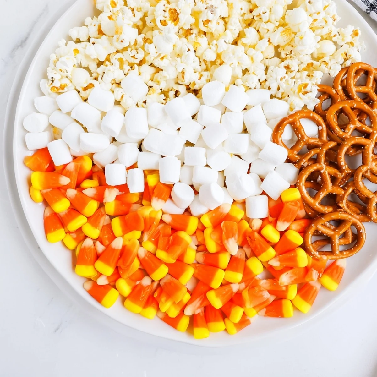Vibrant Candy Corn Spooky Board featuring a delightful mix of candies, cheeses, and fruits ready to serve.