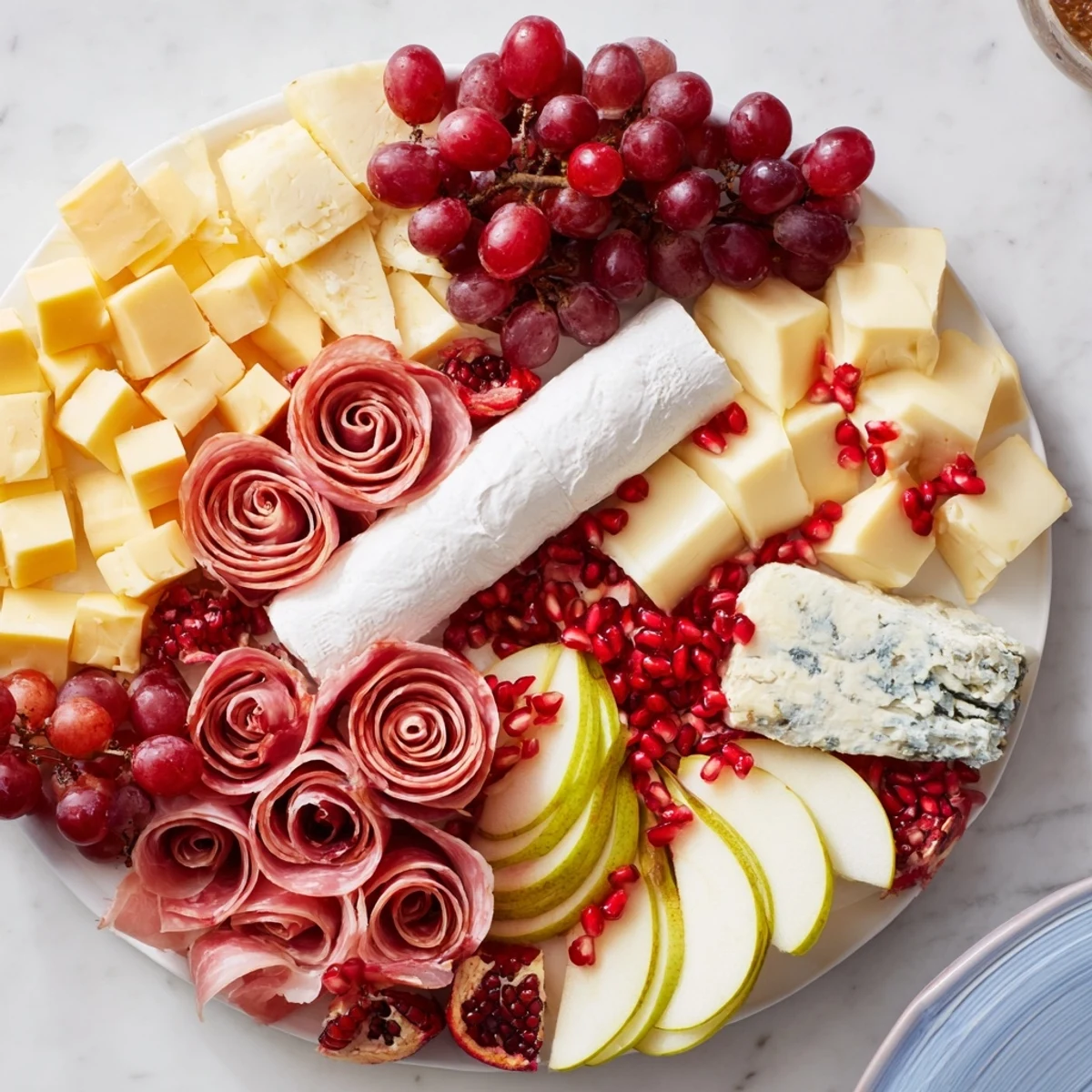 This festive Winter Wonderland Grazing Tray displays colorful fruits and an array of delicious snacks.