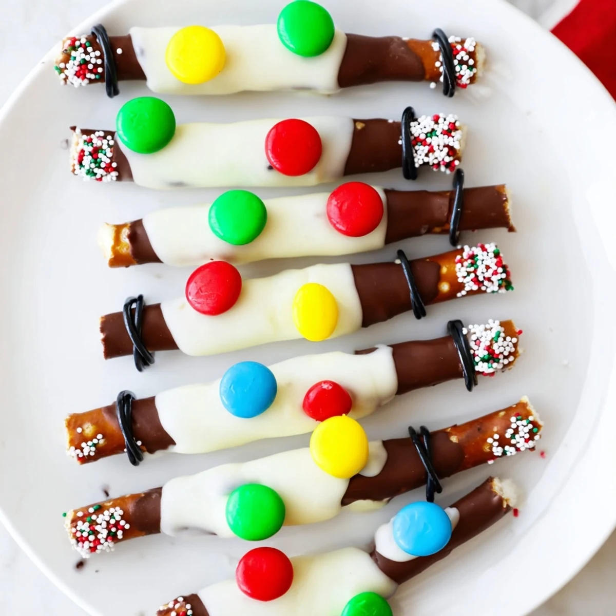Perfectly portioned Pretzel Sticks and Dip Christmas Lights; each decorated with bright candy melt bulbs.