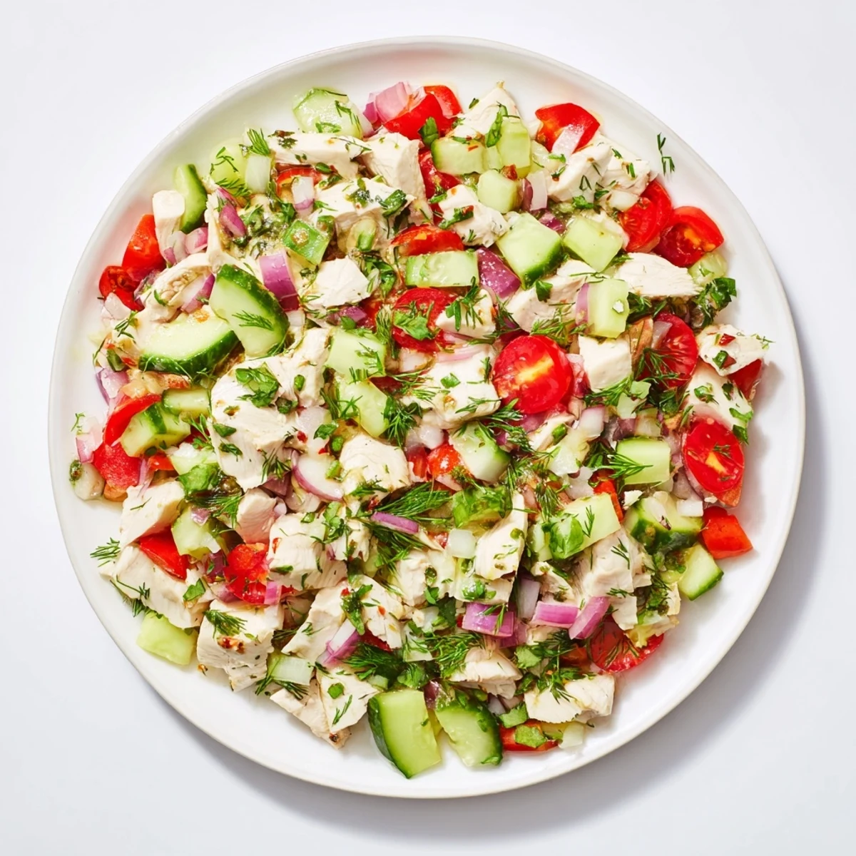 A close-up view of the Cucumber and Chicken Clean Shaker, showing fresh herbs and juicy tomatoes.