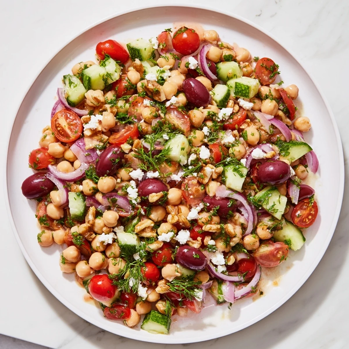 A refreshing bowl of Dense Bean Salad with colorful veggies and a sweet-tart, homemade dressing.