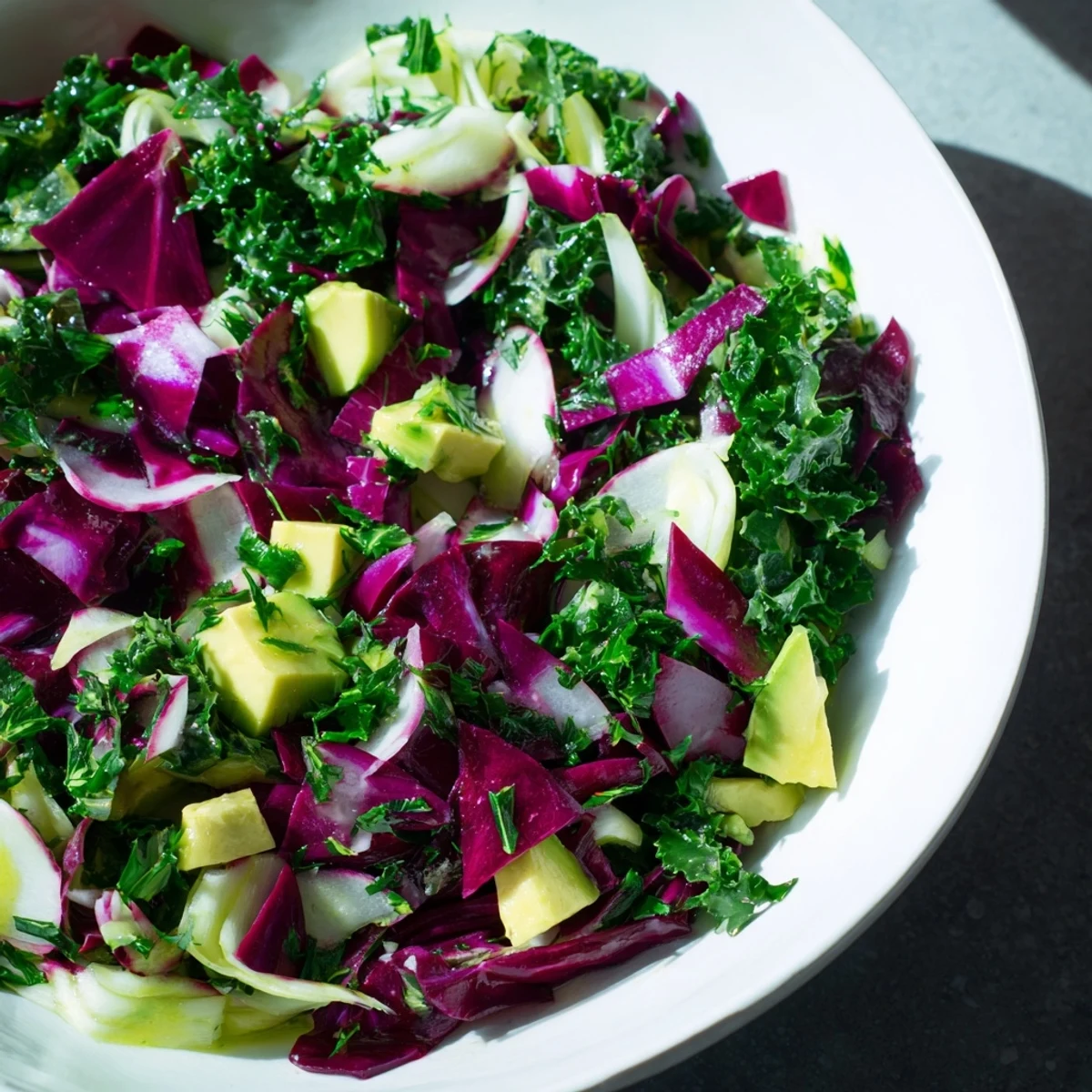 A close-up view of the perfectly tossed Green Goddess Detox Cabbage Salad, ready for serving with colorful ingredients.