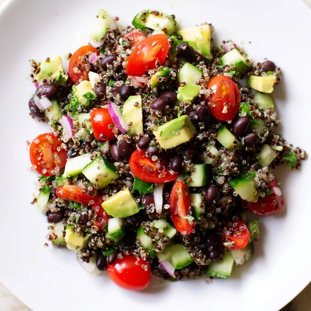 Vibrant quinoa black bean salad, featuring colorful veggies and a tangy lime dressing, is ready to eat.