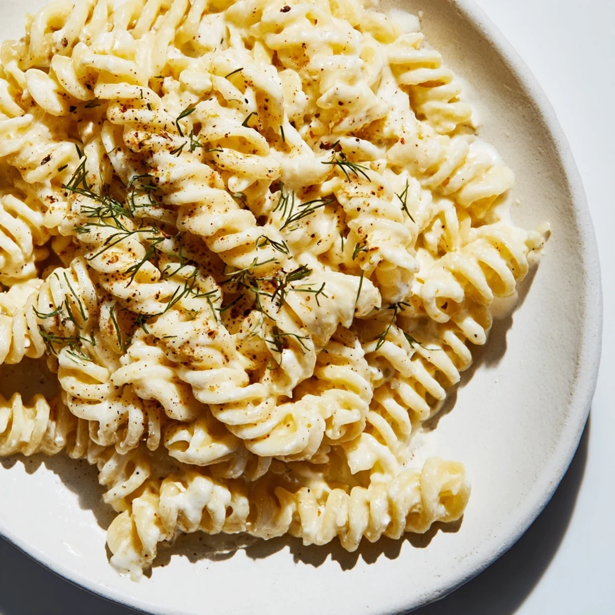 Warm bowl of Turkish Yogurt Pasta, coated in creamy yogurt sauce and drizzled with spiced butter.