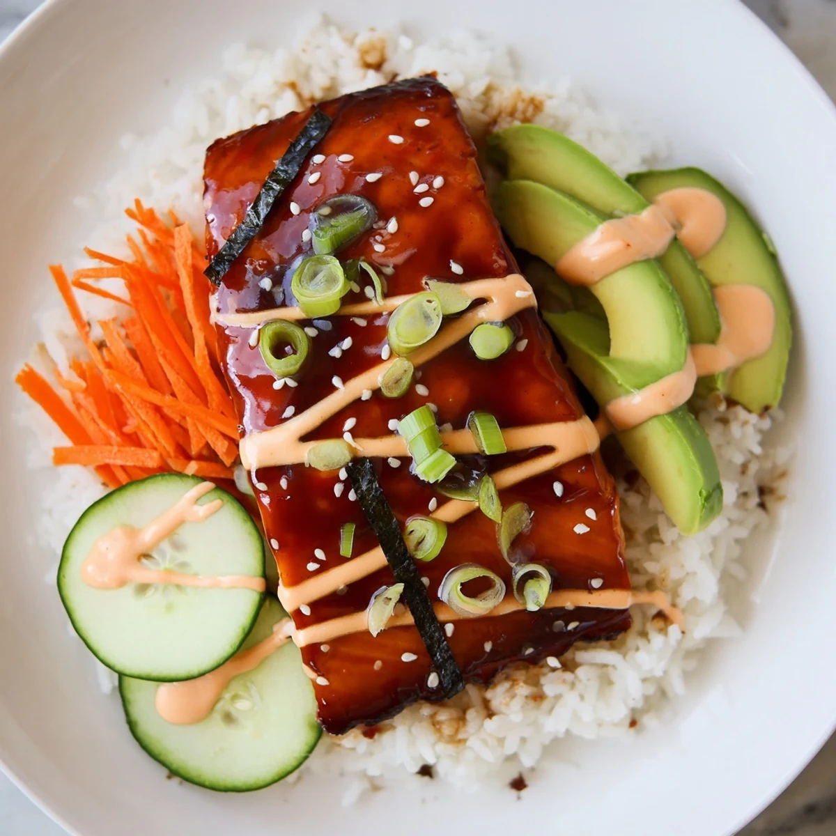 Golden teriyaki salmon rice bowl, flaked salmon atop fluffy rice with vibrant vegetable toppings and sriracha mayo.