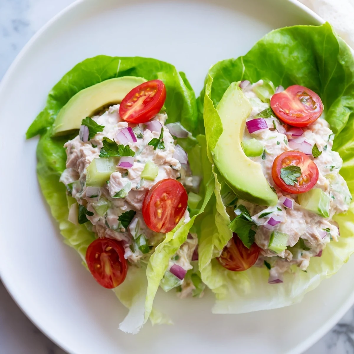 Bright photo of tuna salad lettuce wraps, showing a healthy lunch with fresh ingredients.
