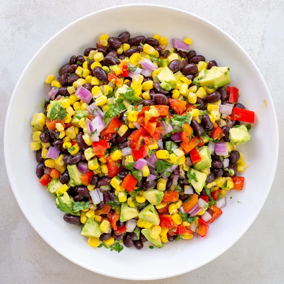 Hearty Southwest Black Bean Salad, a vegetarian delight, ready to be served with tortilla chips.