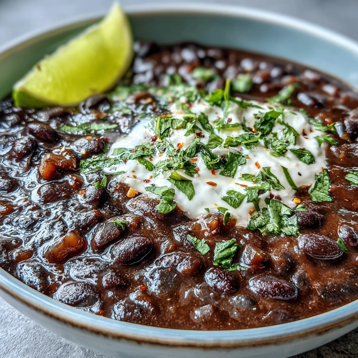 Savory, easy black bean soup topped with avocado slices.