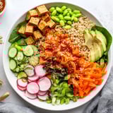 Vibrant fermented vegetable bowl featuring quinoa, kimchi, and bright fresh veggies.  