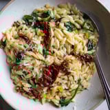 Delicious creamy Tuscan Orzo bowl topped with Parmesan and a drizzle of olive oil.  