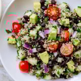 Freshly tossed quinoa black bean salad showcasing juicy tomatoes, perfect for a healthy vegetarian lunch.