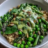 A finished Spring Green Bowl with farro, tender-crisp asparagus, bright green peas, and fresh herbs, ready to serve.