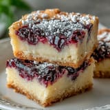 Buttery blackberry lemon bars with a swirled berry pattern, perfect for dessert.