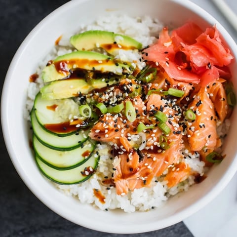 Leftover Salmon & Rice Bowl with creamy avocado and vibrant cucumber slices garnished beautifully.  