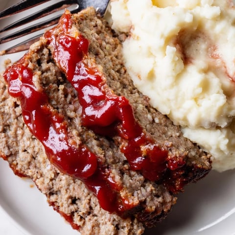 Classic Meatloaf recipe served with creamy mashed potatoes, perfect for cozy family dinners.  