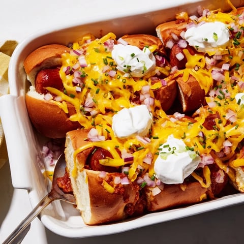 Delicious Chili Dog Casserole topped with melted cheese and fresh chives, perfect for dinner.  