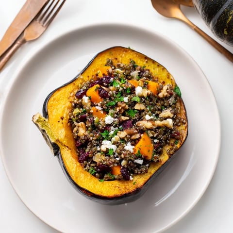 Golden-brown Lentil & Walnut Stuffed Acorn Squash, a visual feast with savory filling and tender squash.