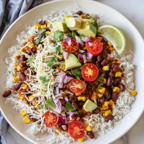 Fluffy rice foundations hold vibrant Rice, Bean, and Corn Burrito Bowls with Tex-Mex flavors.