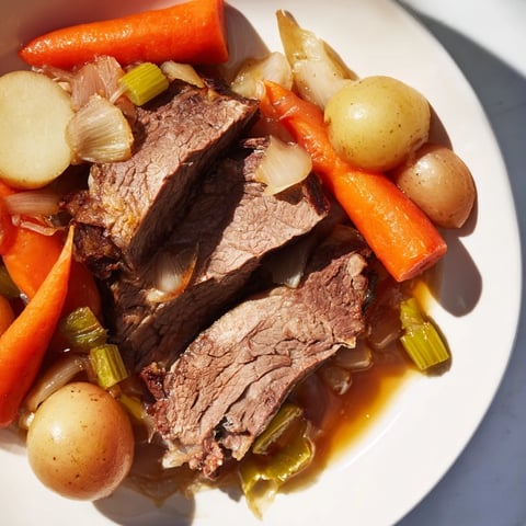 Fork-tender Pickle Brine Pot Roast, slow-cooked with savory vegetables, in rich, flavorful juices.