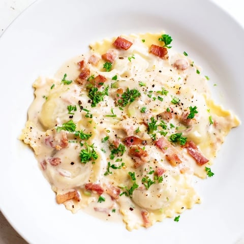 Creamy Olive Garden Ravioli Carbonara with crispy pancetta, perfect for a comforting Italian dinner.