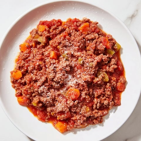 Classic Tuscan Ragu simmering slowly, a rich meat sauce ready for pasta and cheese.