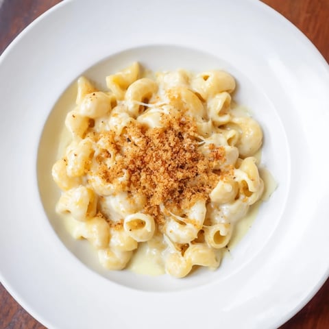 Golden, bubbly Easy Tinis Mac & Cheese, with a creamy cheese sauce over elbow macaroni, ready to eat.
