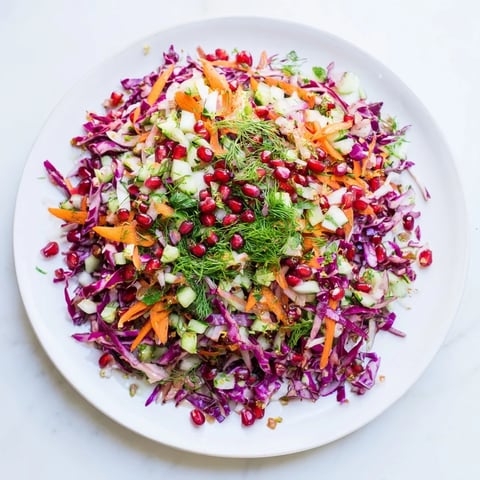 A vibrant bowl of Shirazi-Inspired Winter Slaw with crunchy vegetables and a zesty dressing.