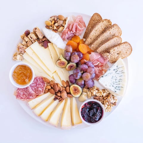 Festive Plateau des Rois Mages Gourmand platter with cheeses, meats, fruits, and nuts ready to share and enjoy.
