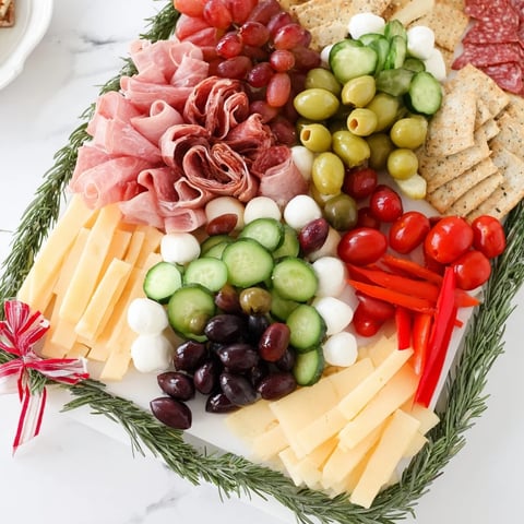 Delicious Christmas Tree Charcuterie Board brimming with meats, cheeses, and fresh colorful fruits to share.