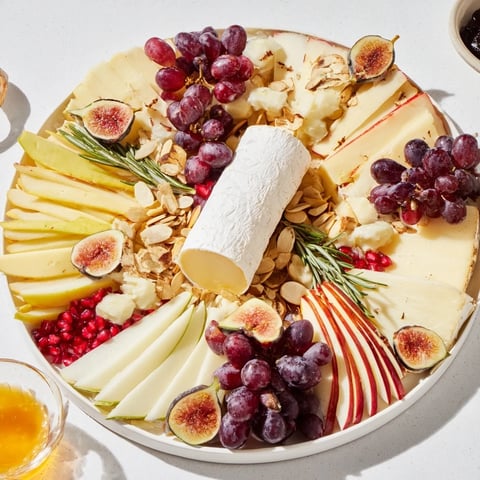 A beautiful Star of Bethlehem cheese platter arranged with colorful fruits and gourmet treats for serving.