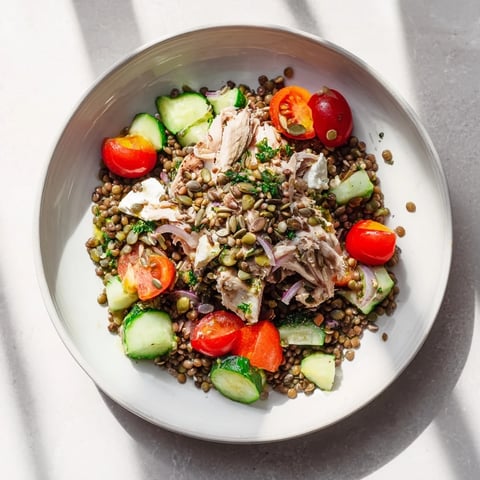 Chicken and Lentil Recession Salad bursting with colors: juicy tomatoes, cucumber, carrots, and parsley.
