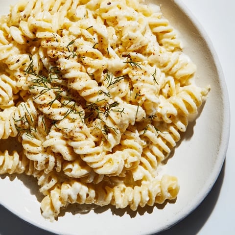 Warm bowl of Turkish Yogurt Pasta, coated in creamy yogurt sauce and drizzled with spiced butter.