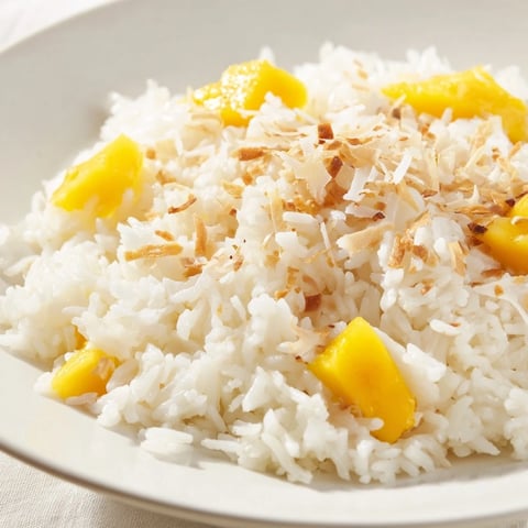 Fluffy coconut rice sweet, garnished with toasted coconut, ready for a delicious dessert.
