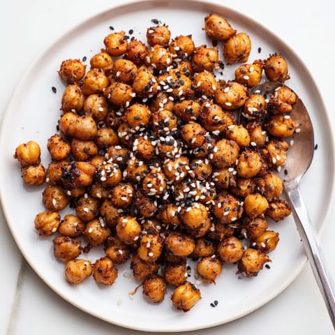 Close-up of crunchy Crispy Sesame Chickpeas, speckled with seeds, a flavorful vegan snack.