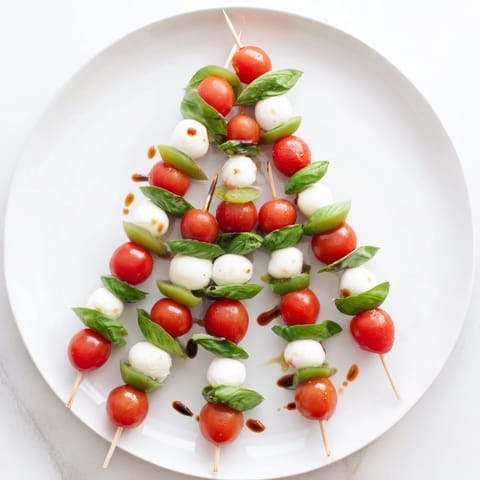 Festive Caprese Skewer Tree, showcasing juicy tomatoes, mozzarella, and fragrant basil ready to serve.