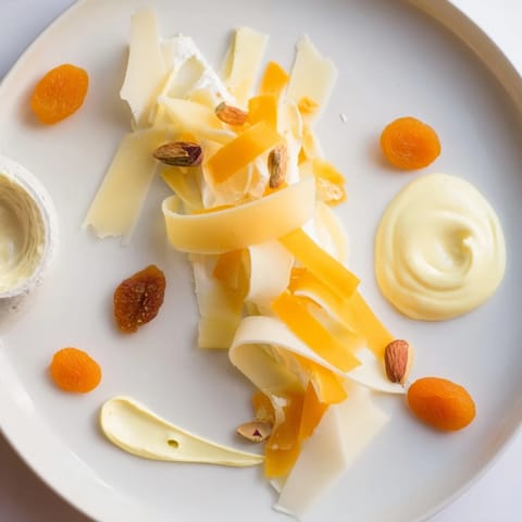 Elegant The Saffron Silk appetizer features rich, saffron-tinged cheeses artfully arranged for easy sharing.