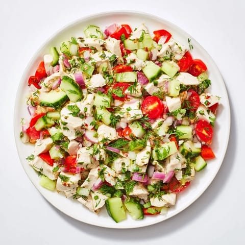 A close-up view of the Cucumber and Chicken Clean Shaker, showing fresh herbs and juicy tomatoes.