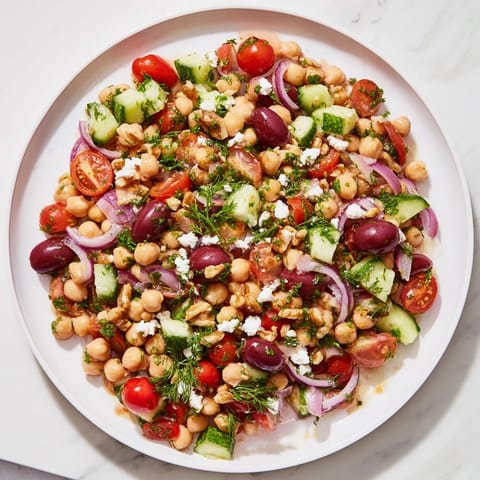 A refreshing bowl of Dense Bean Salad with colorful veggies and a sweet-tart, homemade dressing.