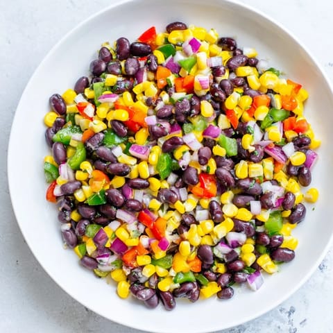Close-up of a flavorful Cowboy Caviar Salad showcasing fresh black beans and zesty lime dressing.