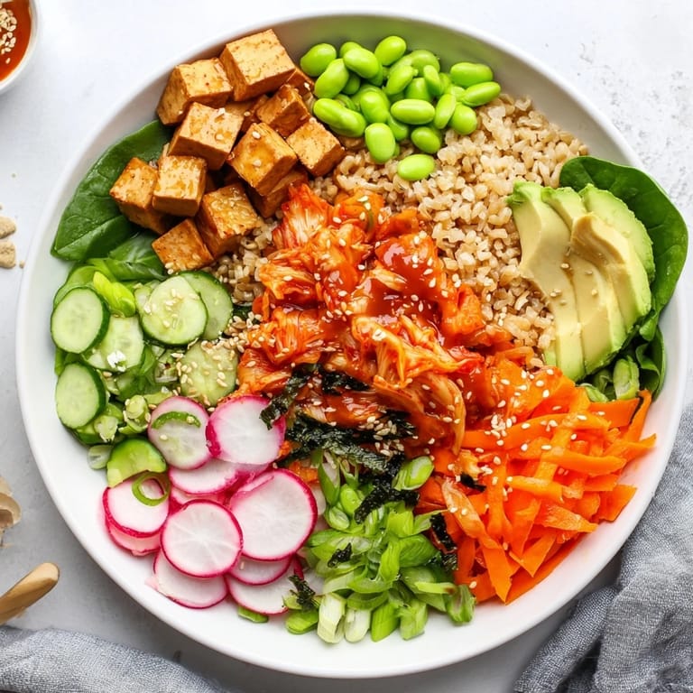 Vibrant fermented vegetable bowl featuring quinoa, kimchi, and bright fresh veggies.  