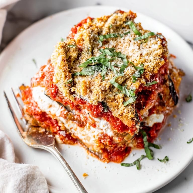 Golden-browned eggplant Parmesan lasagna, rich in tomato sauce and creamy cheeses.  