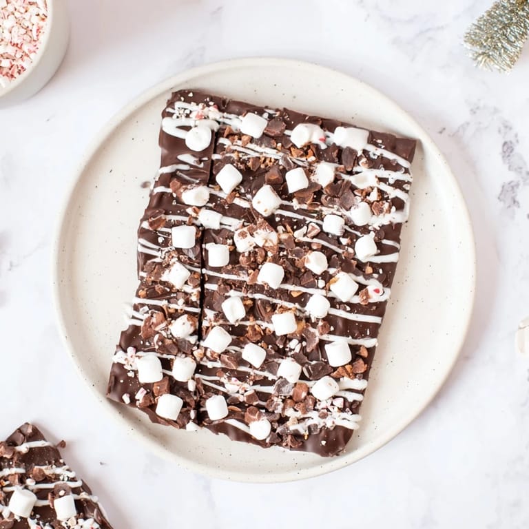 White chocolate drizzled over the festive Hot Chocolate Bomb Bark, ready for sharing and enjoyment.