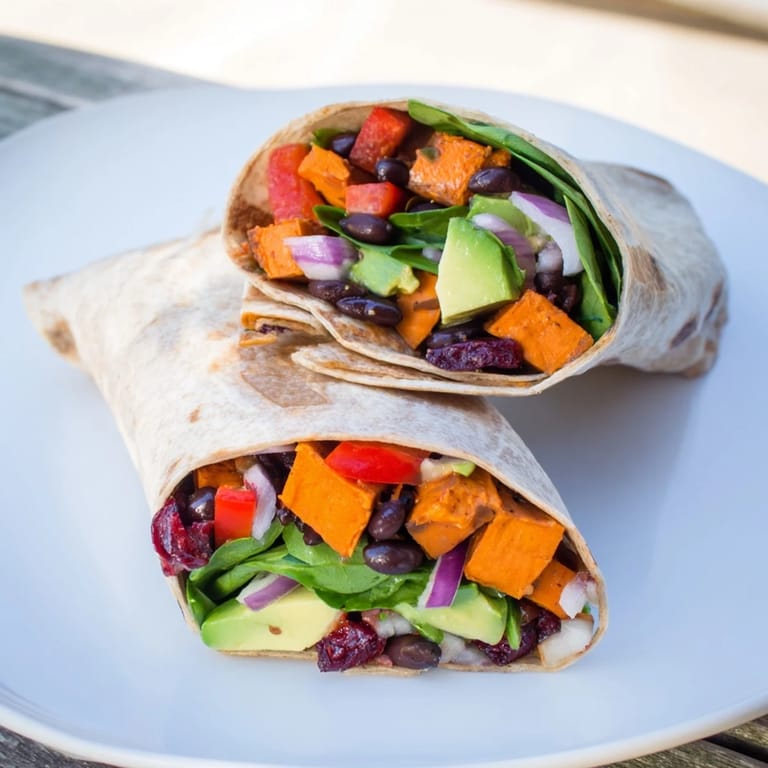 Golden roasted sweet potatoes and black beans filling a delicious Holiday Wrap, offering a tasty meal.