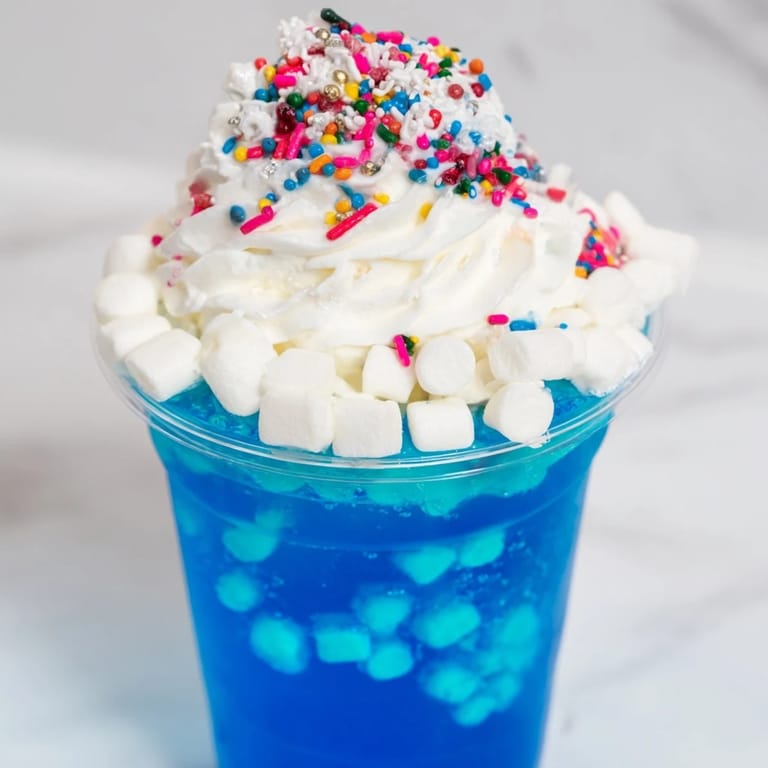 These enchanting snow globe Jello cups feature a playful, colorful display of gelatin, sprinkles, and marshmallows.