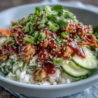 Fluffy rice bowls topped with tender ground turkey in spicy Bang Bang sauce, loaded with crunchy carrots, cucumbers, and red cabbage.